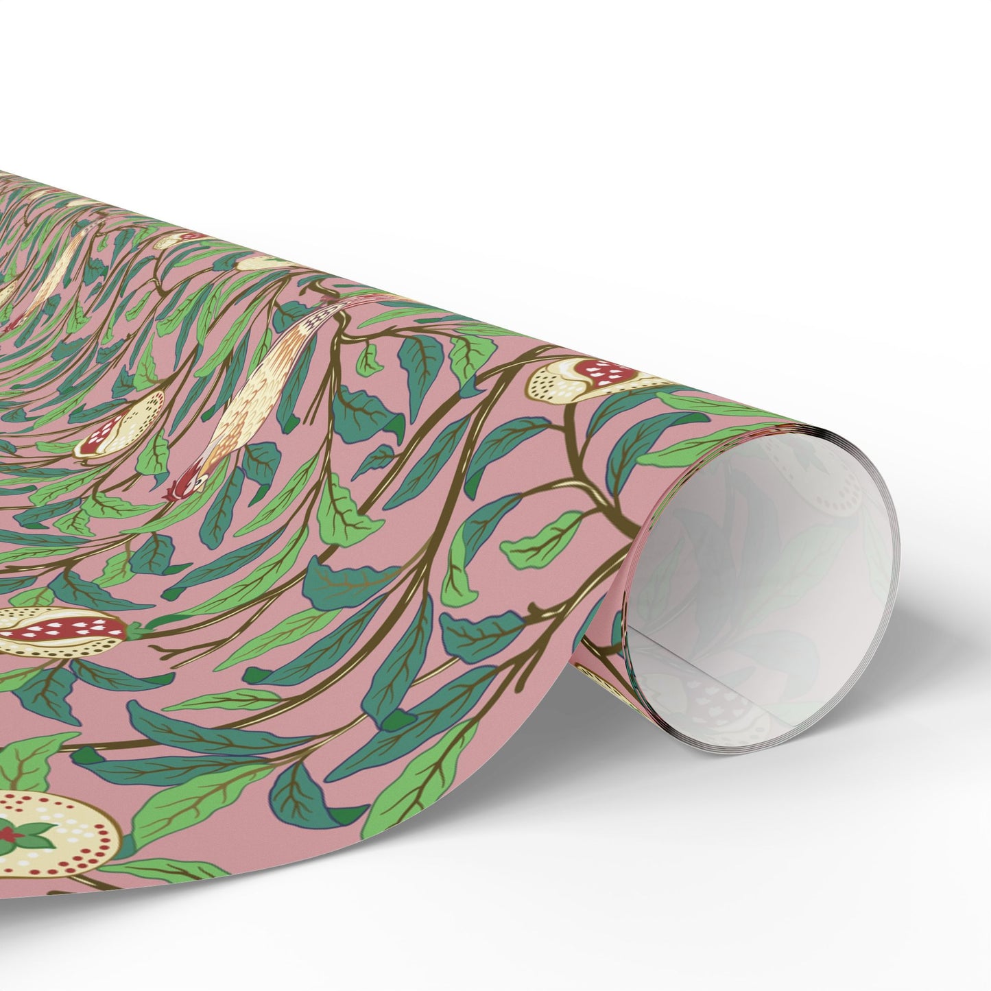 Roll of floral-patterned paper with green leaves and pink background on a white surface