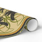 Roll of decorative paper with black bird and green leaf pattern on a beige background