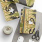 Gift-wrapped packages with decorative patterns on a white surface with scissors and yarn.