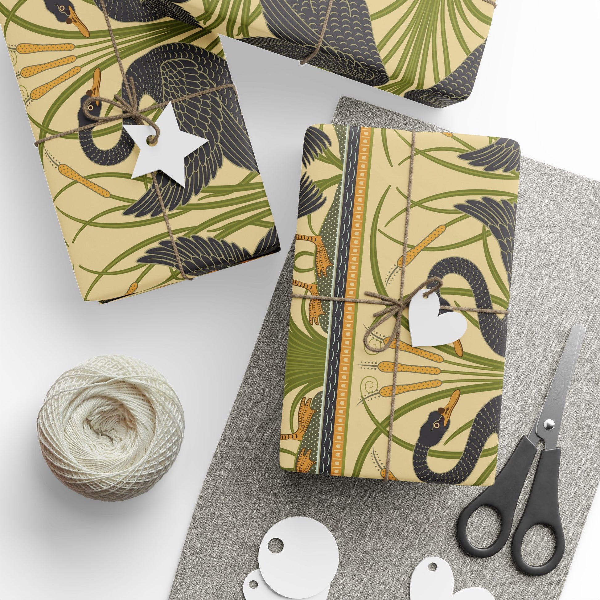 Gift-wrapped packages with decorative patterns on a white surface with scissors and yarn.