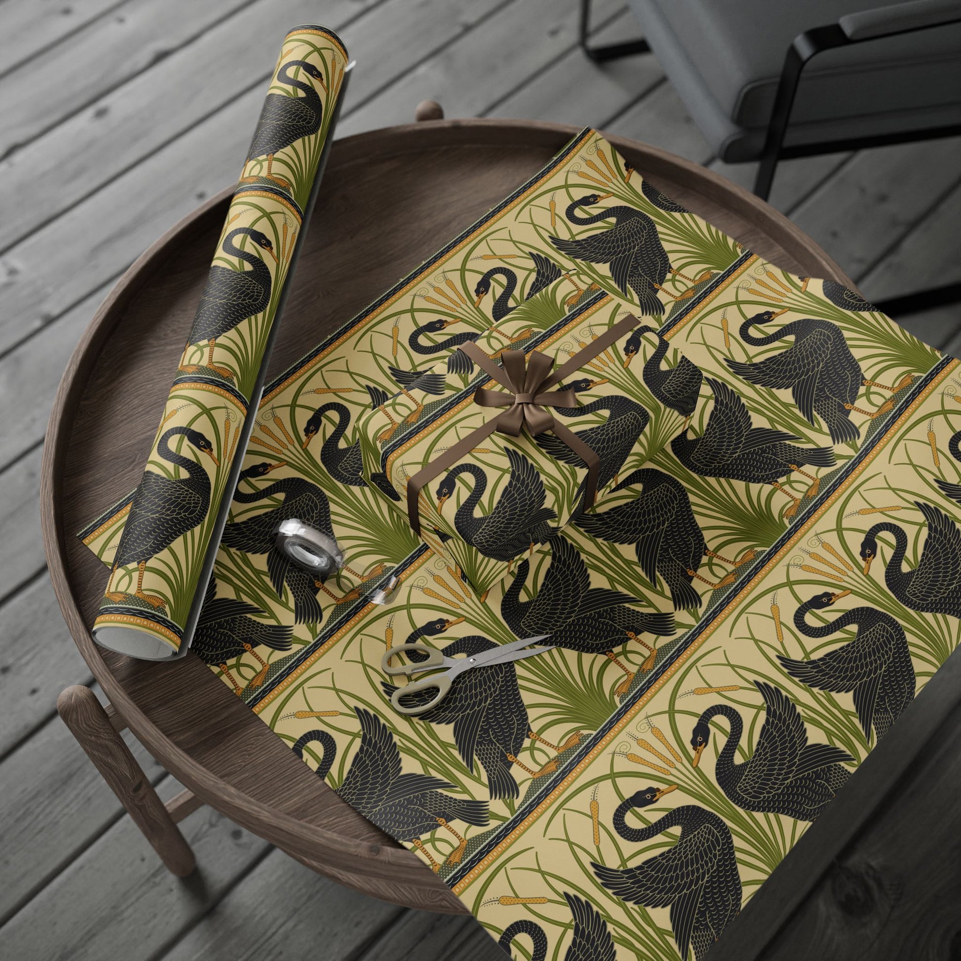 Decorative tablecloth with black swan design on a wooden tray