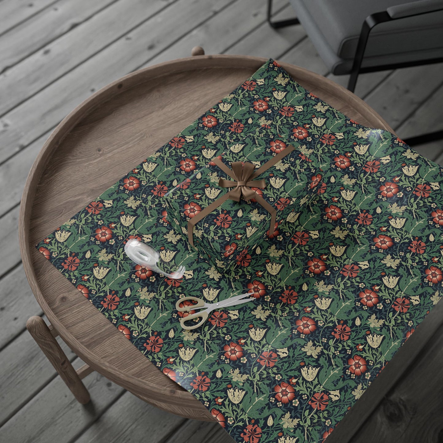 Floral-patterned mat on a wooden tray with a spider decoration on a wooden floor.