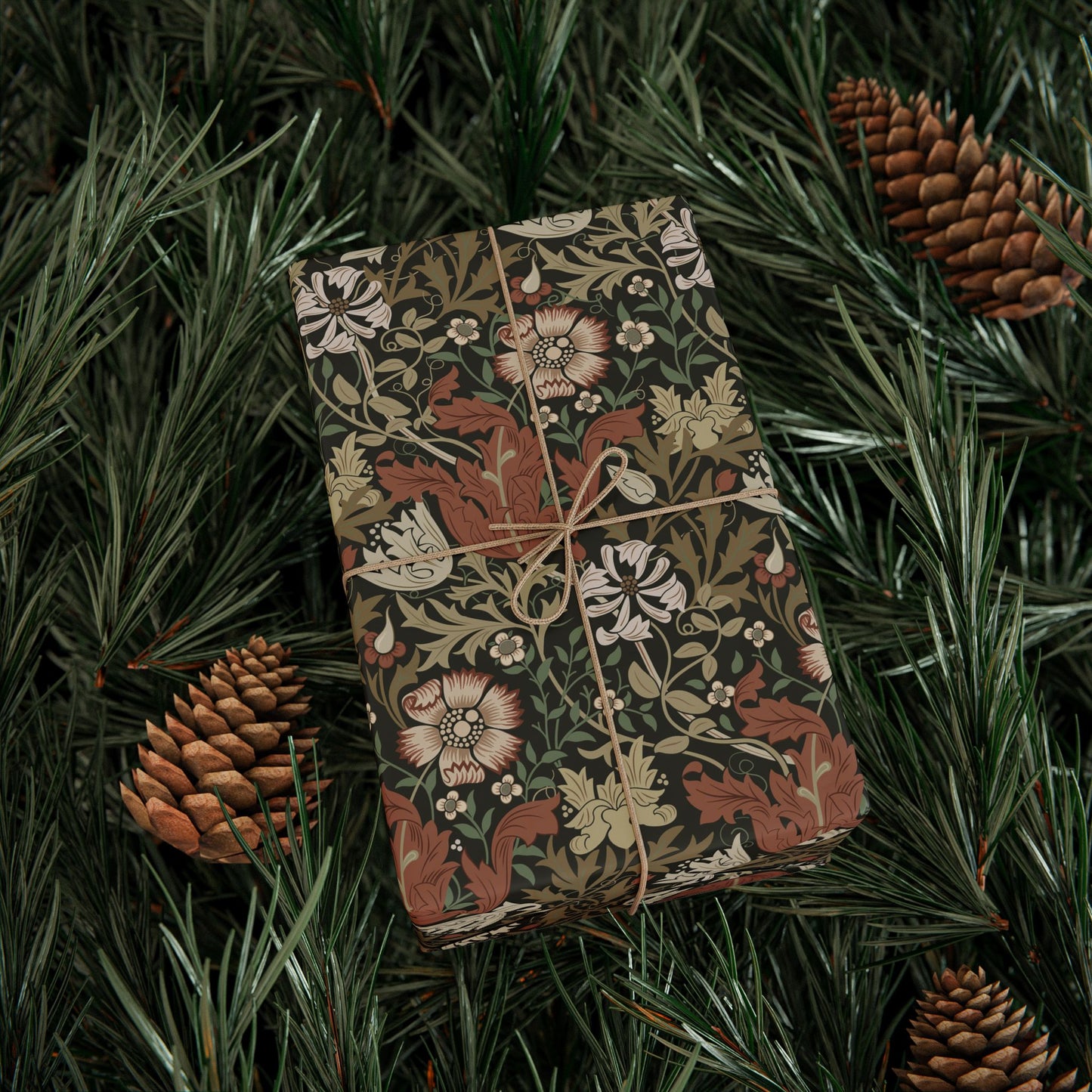 Decorative box with floral pattern on green foliage with pine cones