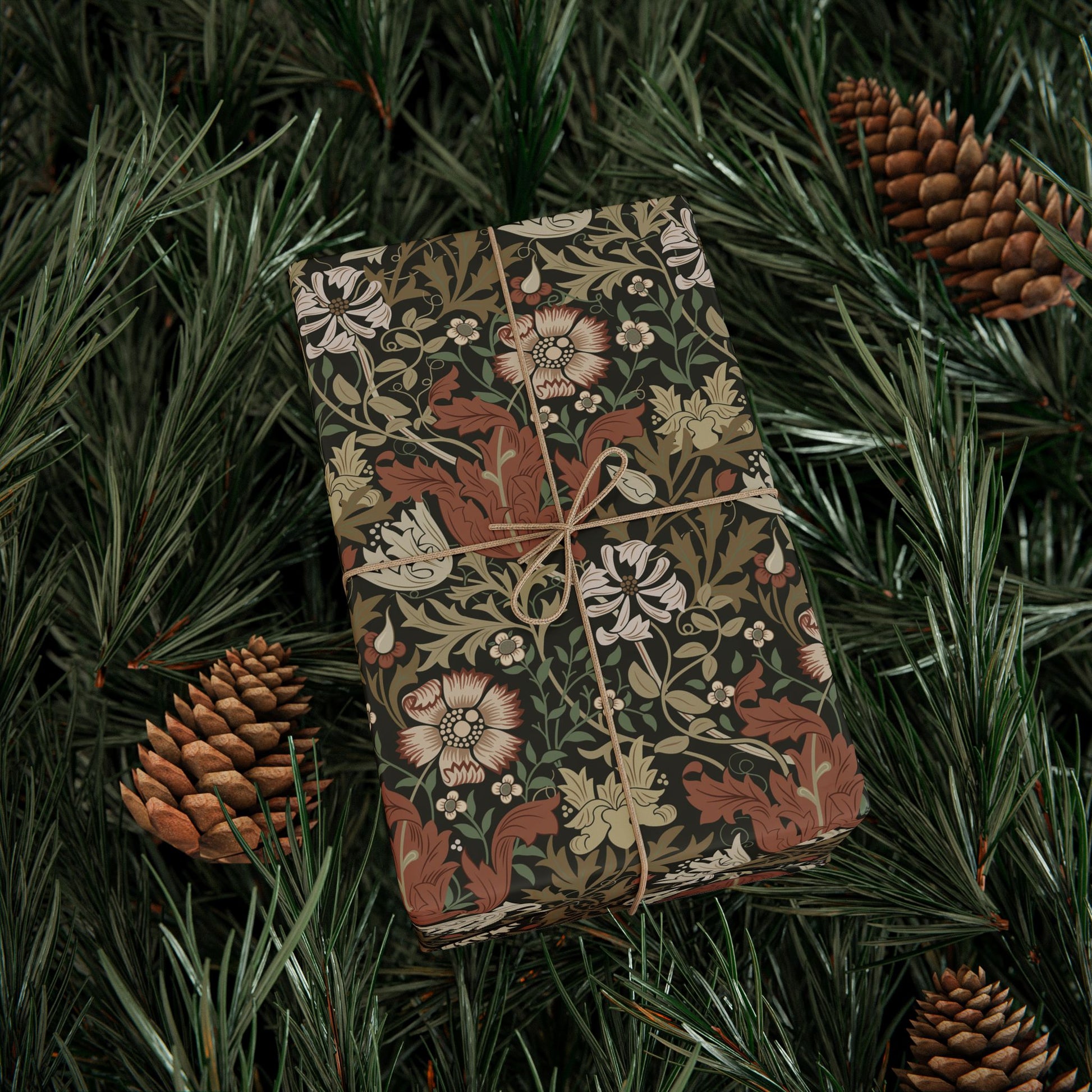 Decorative box with floral pattern on green foliage with pine cones