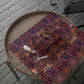 Patterned fabric with scissors on a wooden tray outdoors