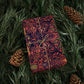Decorative notebook with floral pattern tied with string on a green leafy background