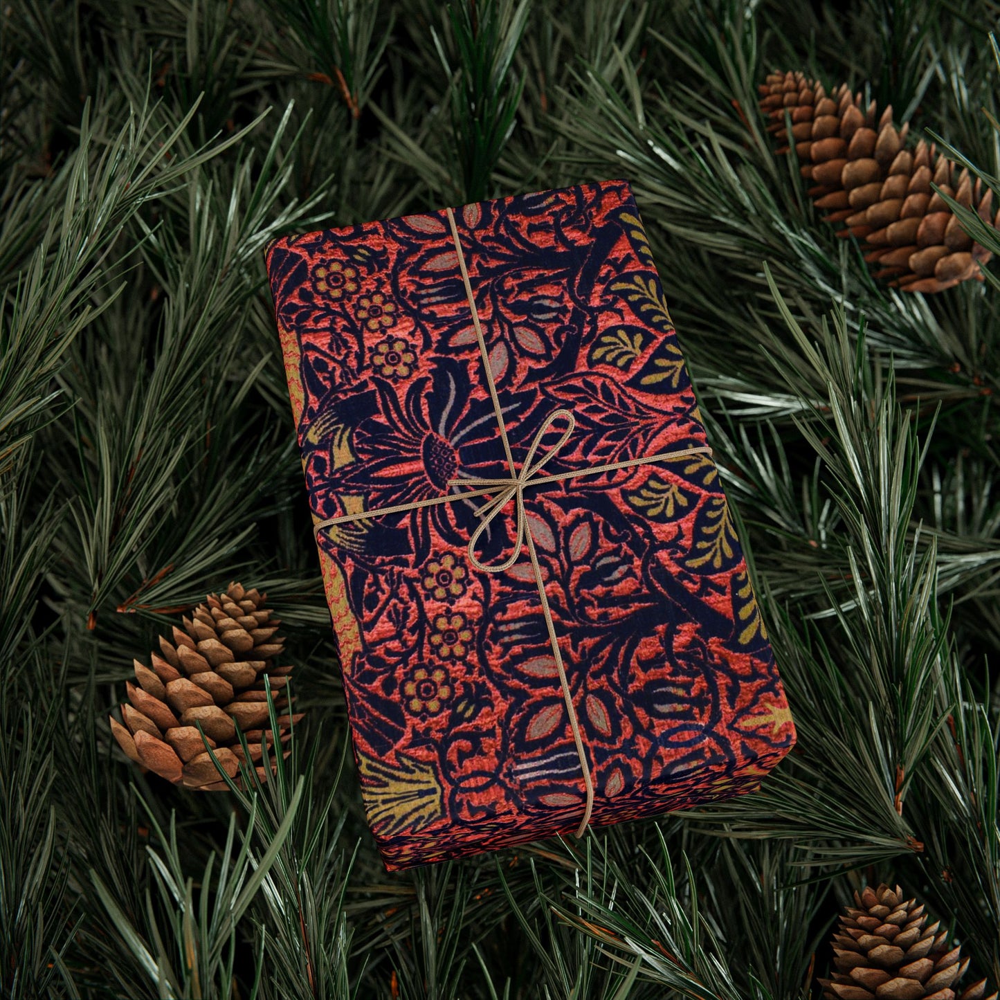 Decorative notebook with floral pattern tied with string on a green leafy background