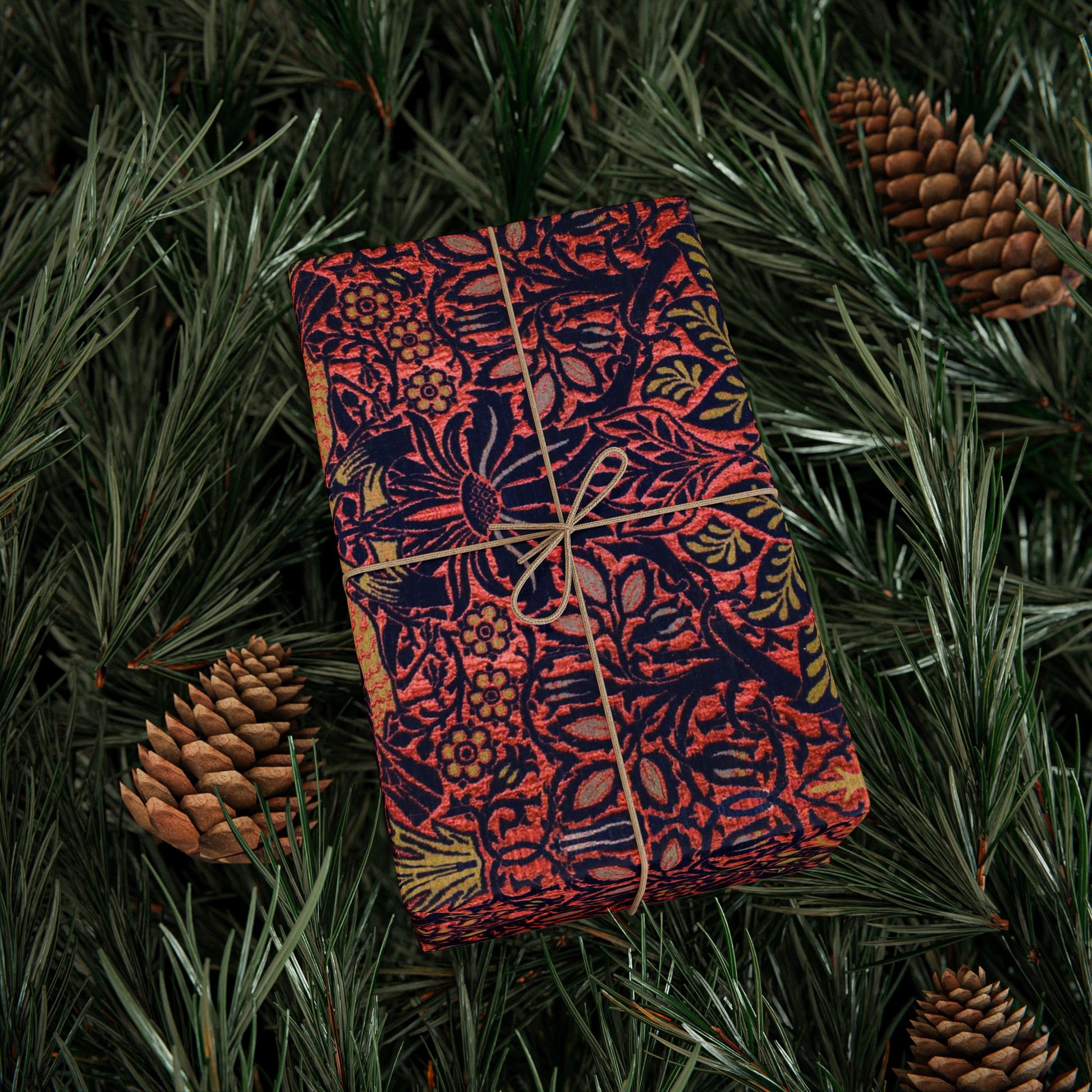 Decorative notebook with floral pattern tied with string on a green leafy background
