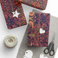 Decorative fabric roll with floral pattern, scissors, and yarn on a white background