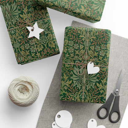 Green patterned gift wrap with decorative tags and scissors on a white surface