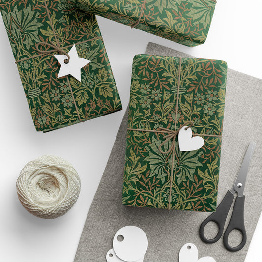 Green patterned gift wrap with decorative tags and scissors on a white surface