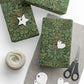 Green patterned gift wrap with decorative tags and scissors on a white surface