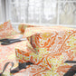 Gift boxes with floral pattern on a table with scissors