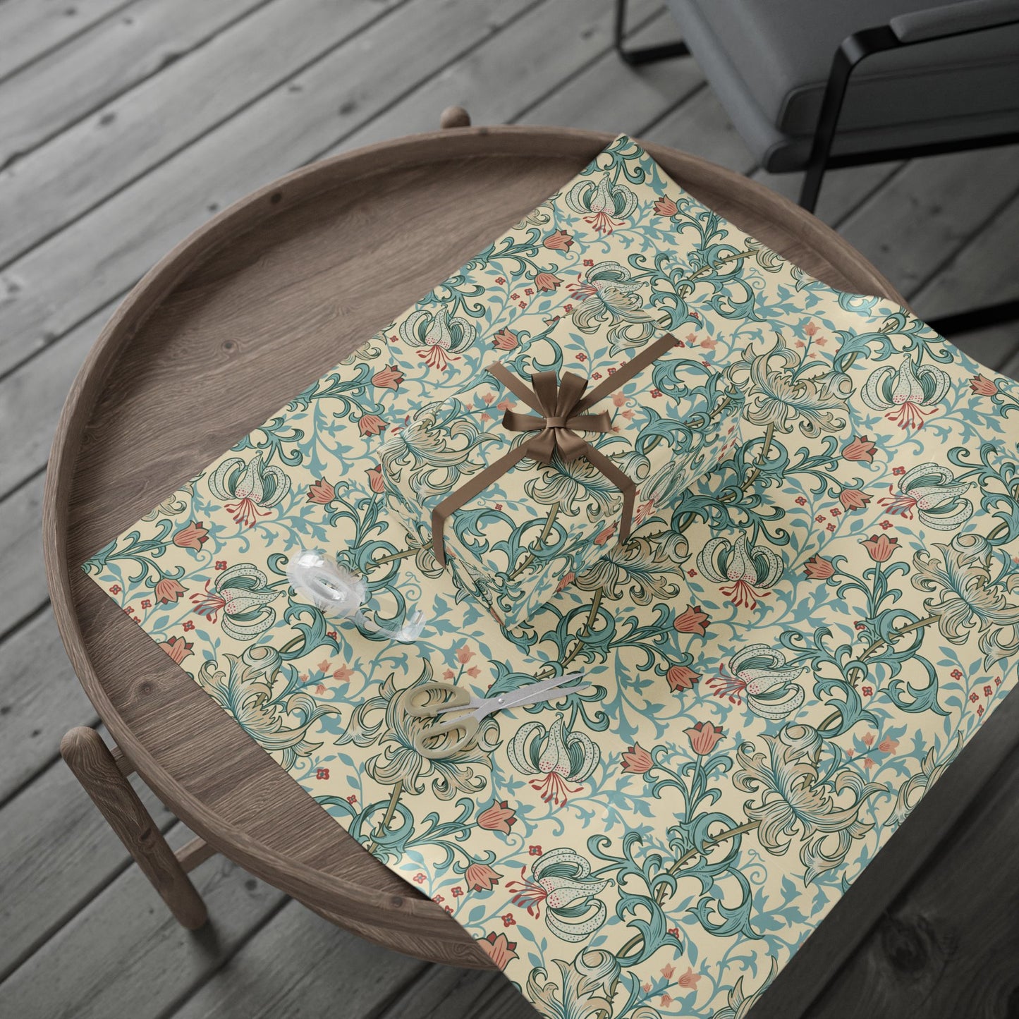 Decorative wrapping paper with floral pattern on a wooden tray outdoors