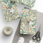 Gift boxes wrapped in decorative paper with a floral pattern, scissors, and twine on a gray surface.