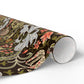 Roll of decorative paper with intricate floral and dragon design on a white background