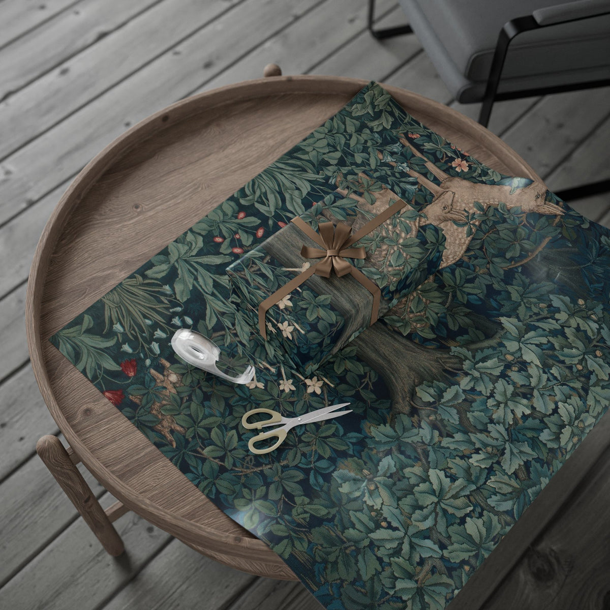 Wooden tray with a green patterned cloth, scissors, and decorative items on a wooden surface.