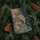 Wrapping paper with fox design tied with twine on green leaves and pine cones
