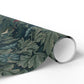 Roll of decorative paper with leaf pattern on a white background