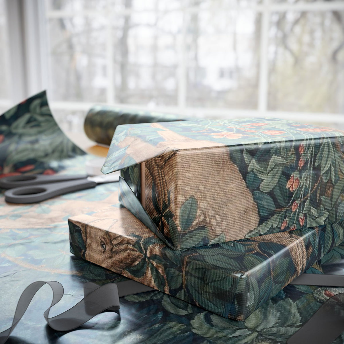 Gift box wrapped in floral-patterned paper with scissors on a table.