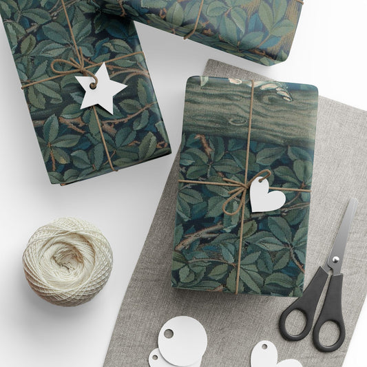 Gift boxes wrapped in green leaf-patterned paper with decorative tags and scissors on a white surface.