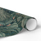 Roll of green leaf-patterned paper on a white background