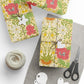 Gift wrap with floral design, scissors, and yarn on a white surface