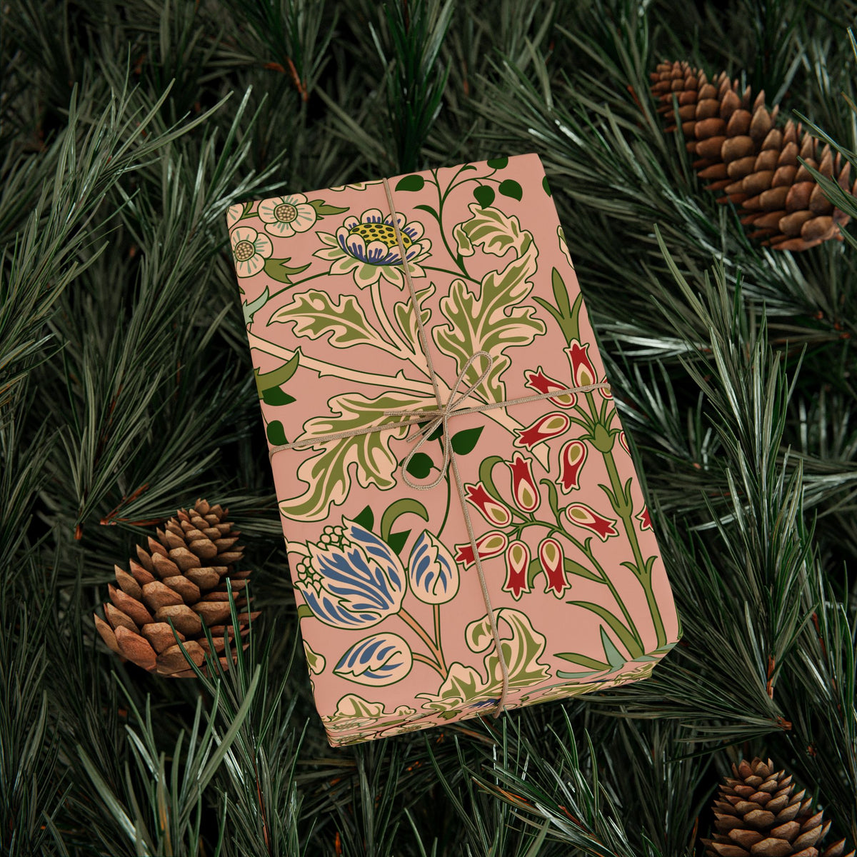 Floral-patterned box on a bed of pine needles and pine cones