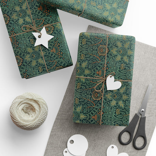 Green patterned gift wrap with decorative tags and scissors on a white surface