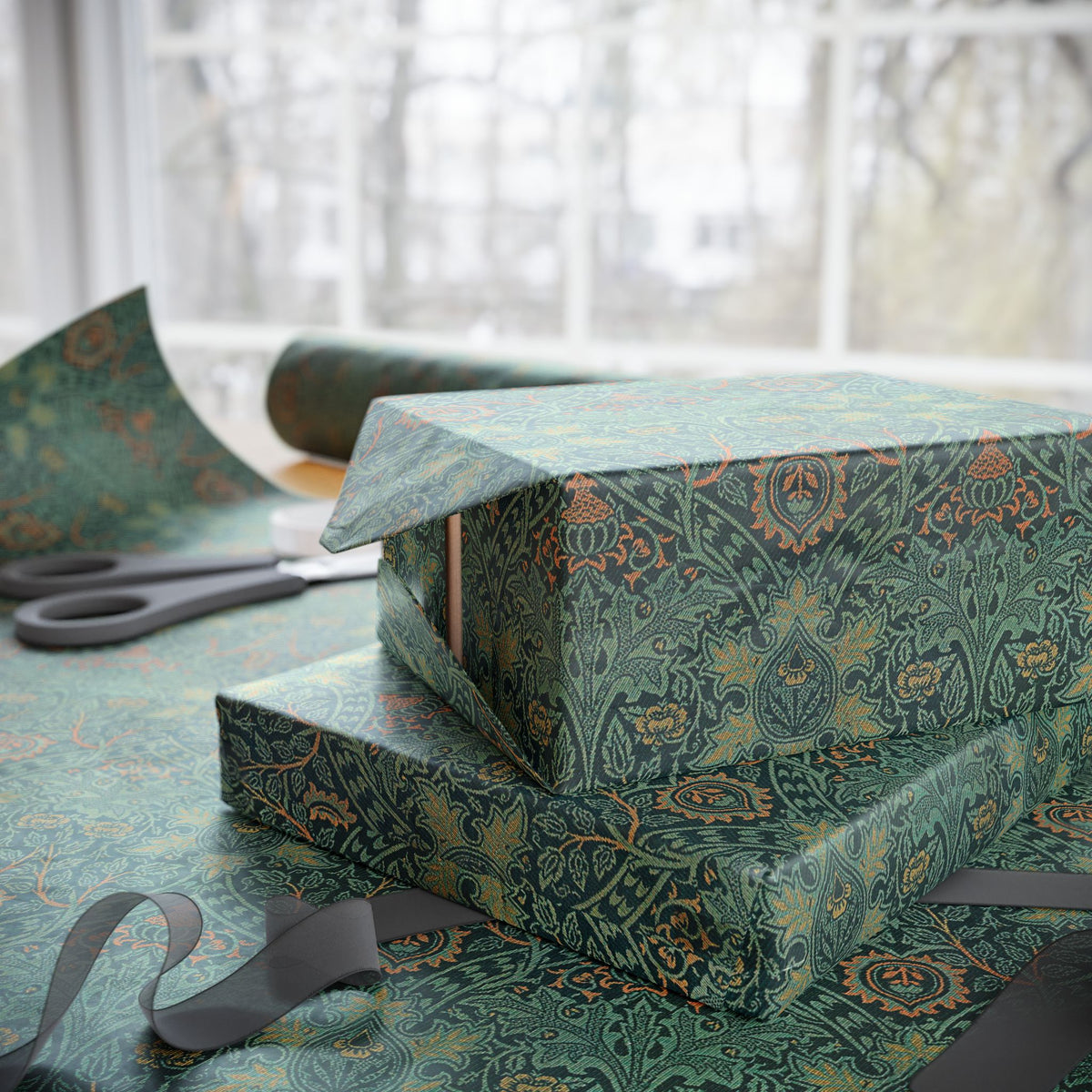 Green patterned gift box with wrapping paper and scissors on a table