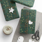 Green patterned gift wrap with decorative tags and scissors on a white surface