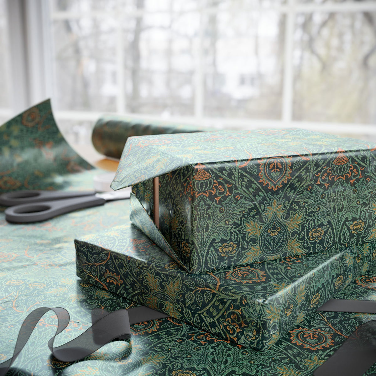 Gift box wrapped in green patterned paper with scissors on a matching tablecloth.