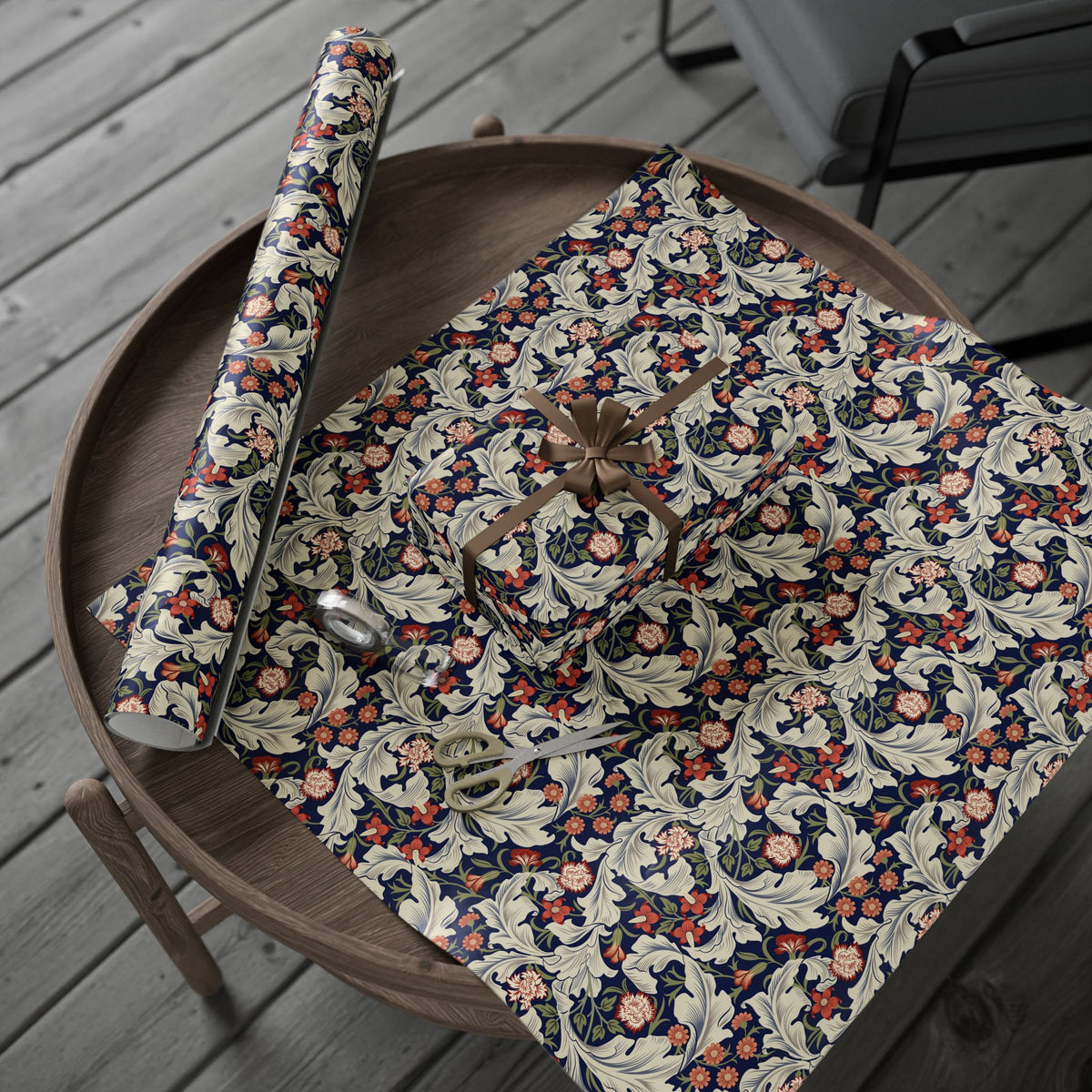 Floral-patterned wrapping paper on a wooden surface with a chair in the background