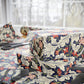 Floral patterned bed sheets on a bed with a blurred background