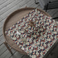 Floral-patterned wrapping paper on a wooden tray with a rustic background