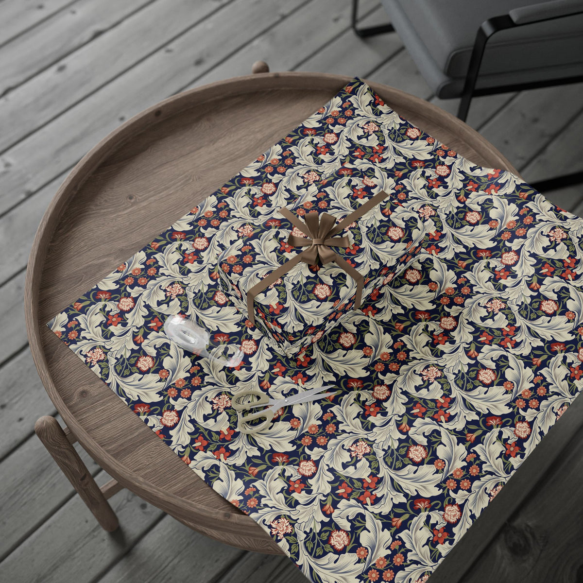 Floral-patterned wrapping paper on a wooden tray with a wooden chair in the background.