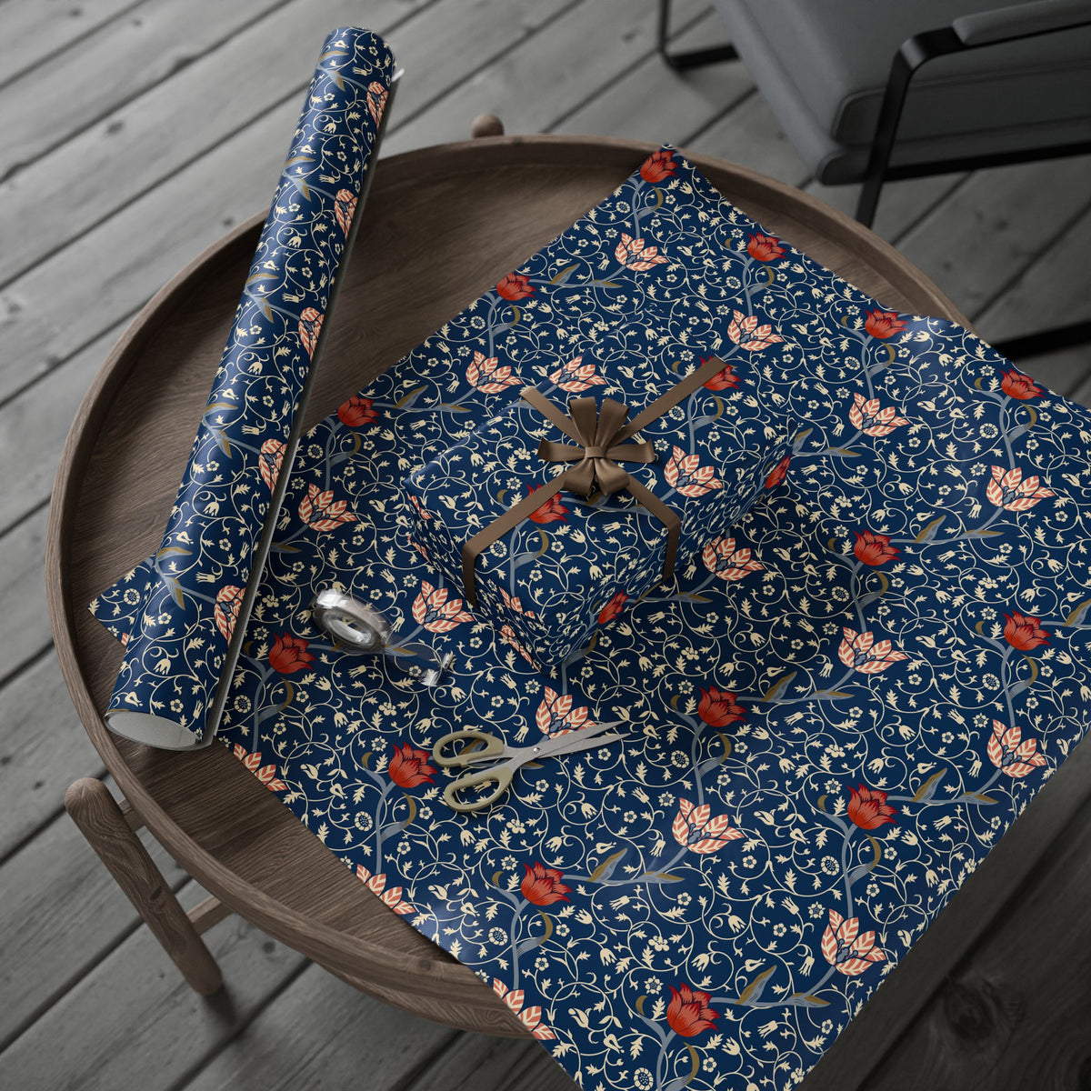Floral-patterned paper with scissors on a wooden surface