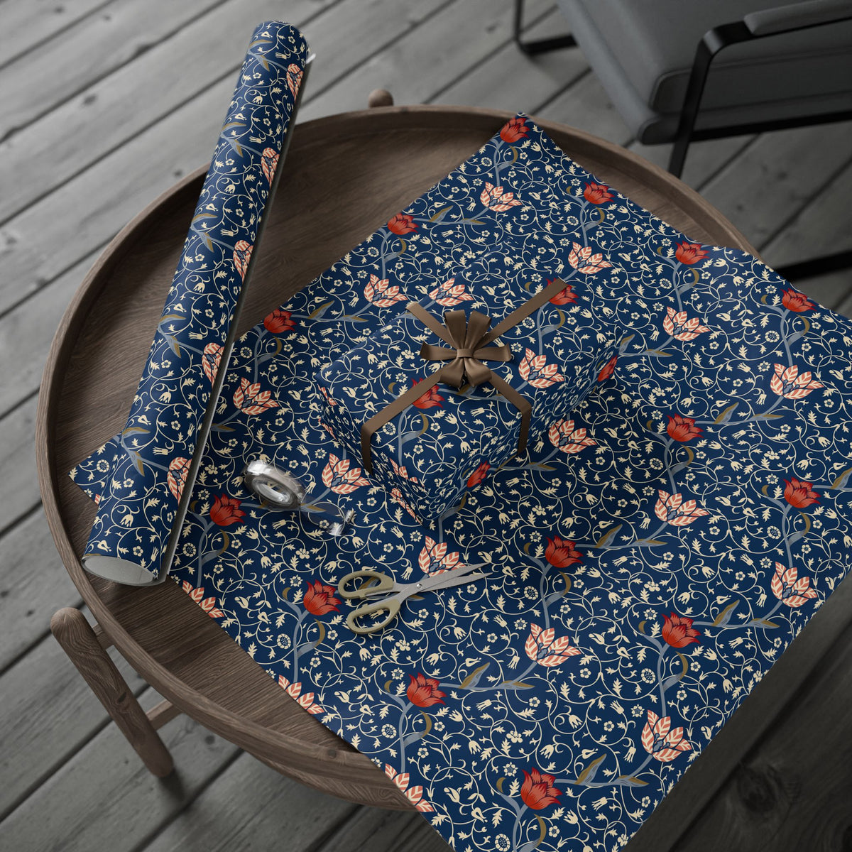 Decorative blue wrapping paper with floral pattern on a wooden surface