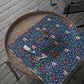 Decorative blue fabric with floral pattern on a wooden tray