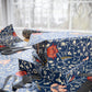 Stack of wrapped presents with floral pattern on a table