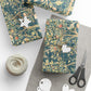 Gift-wrapped packages with decorative paper, scissors, and yarn on a white surface