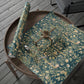 Floral-patterned wrapping paper on a wooden surface with scissors