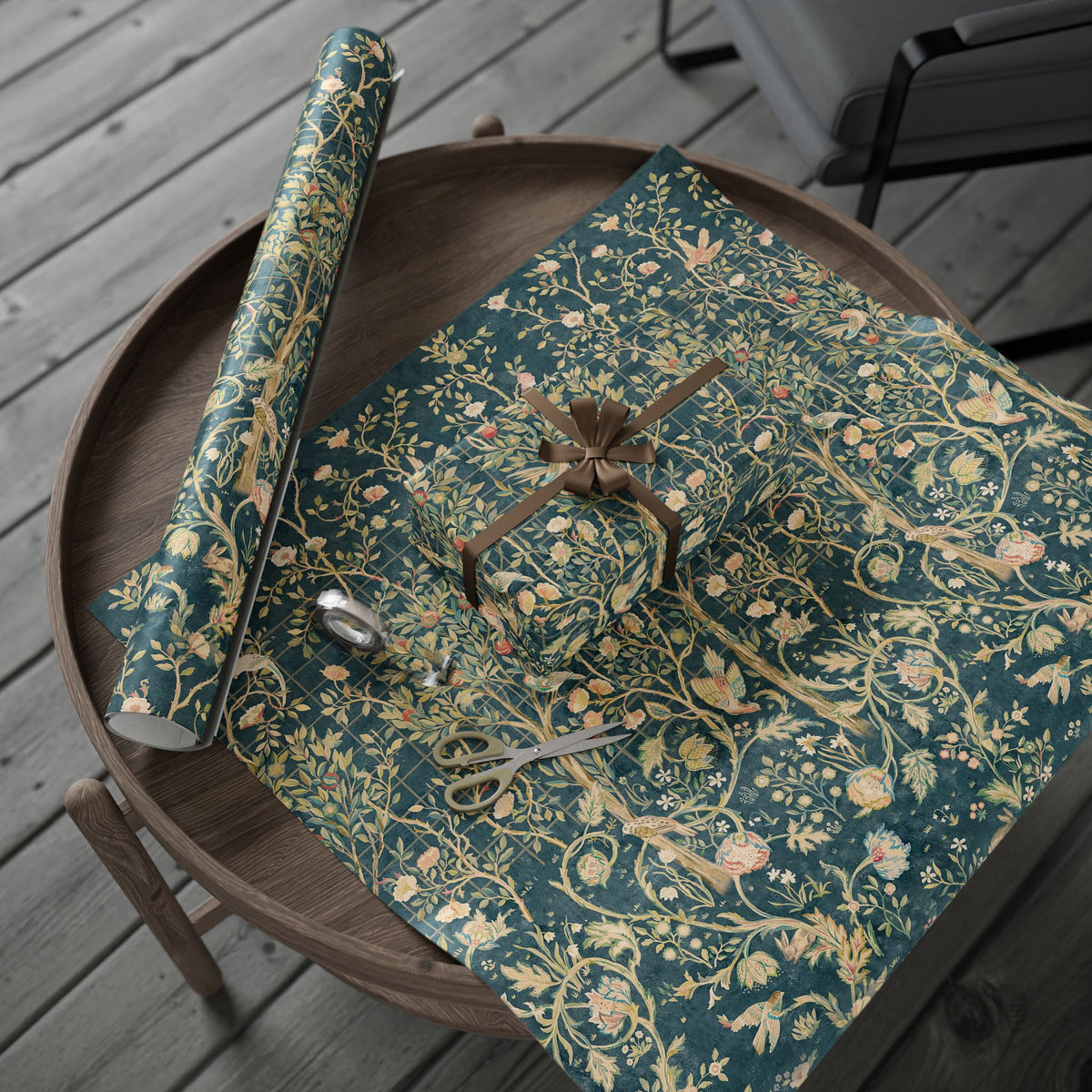 Floral-patterned wrapping paper on a wooden surface with scissors