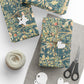 Gift boxes wrapped in decorative paper with a pair of scissors and yarn on a white surface