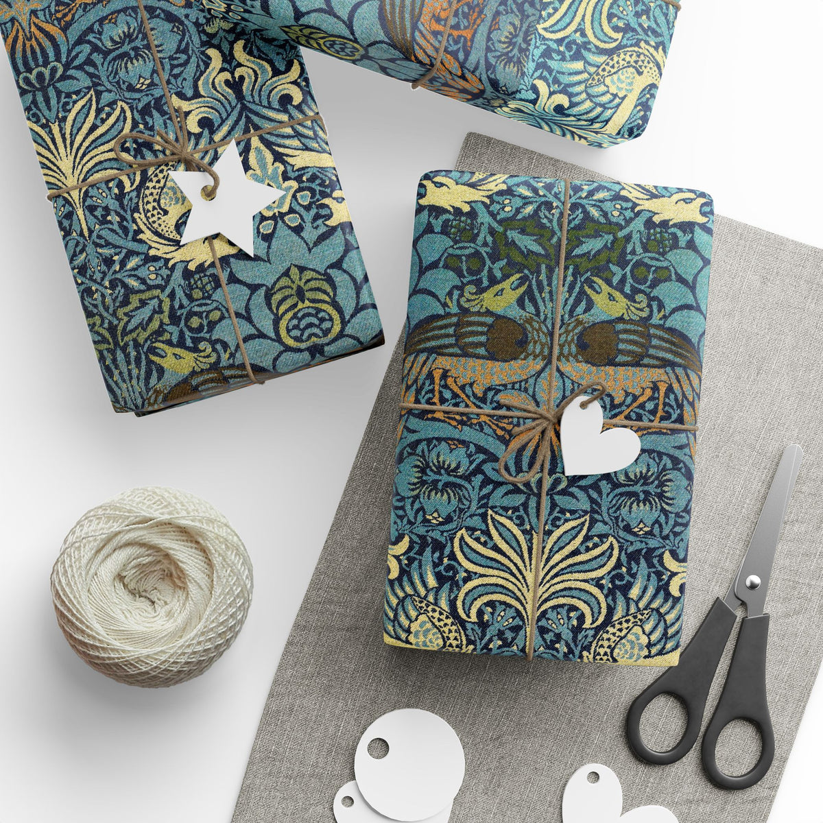 Patterned wrapping paper with scissors and yarn on a white surface
