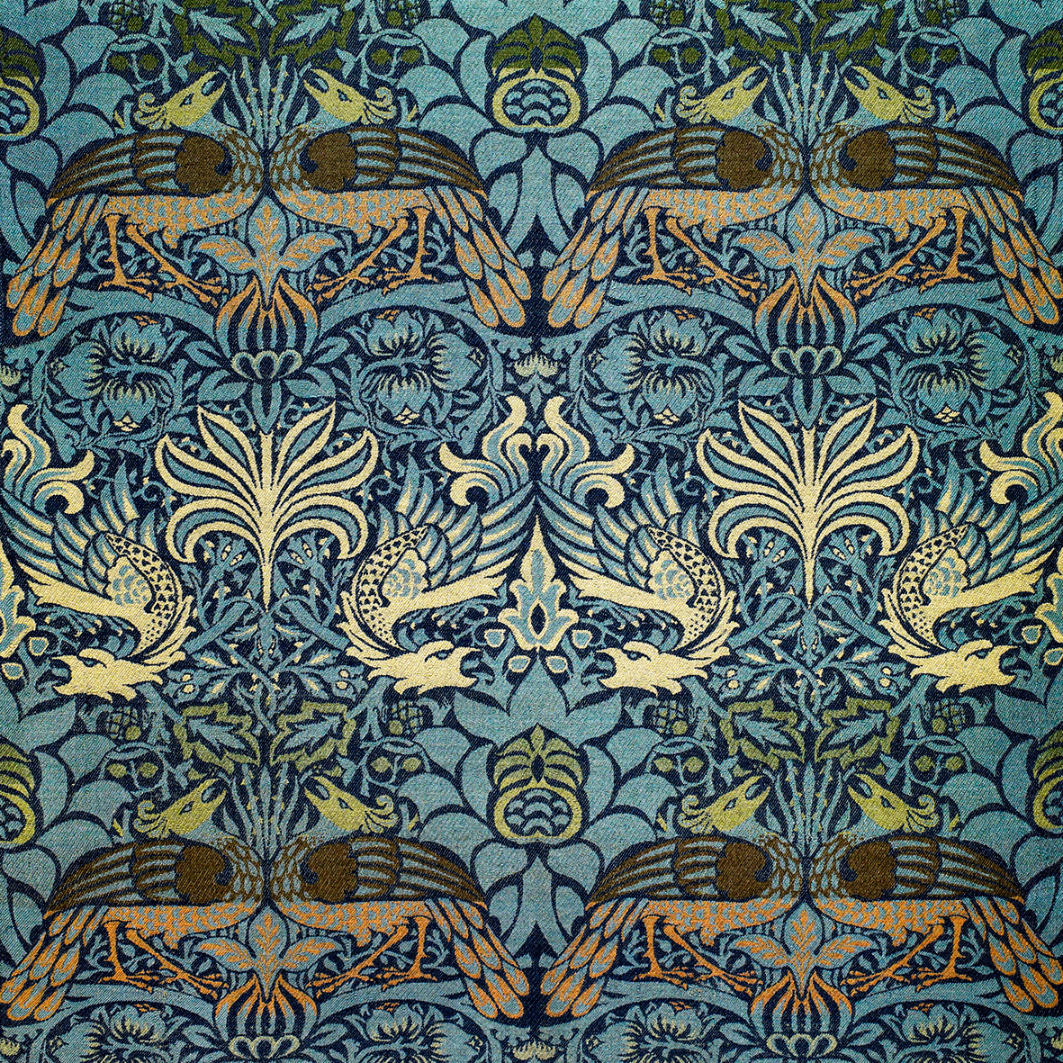 Decorative wrapping paper with intricate pattern of birds and floral elements on a blue background