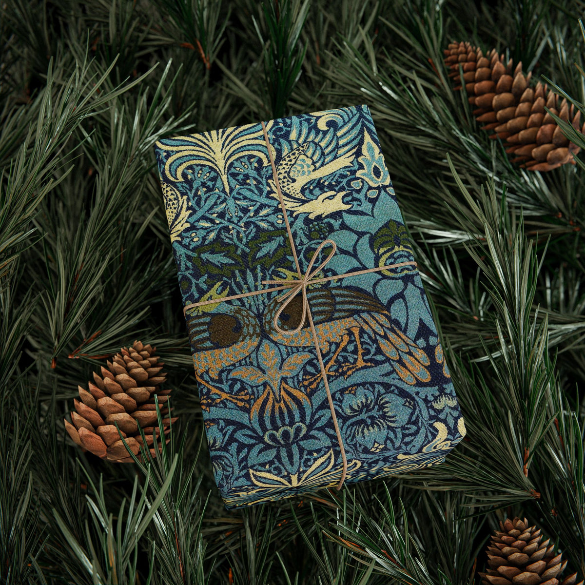 Decorative box with bird pattern on green foliage