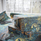 Gift wrapped in decorative paper with scissors on a matching tablecloth.