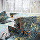 Stack of wrapped presents with decorative paper on a table.