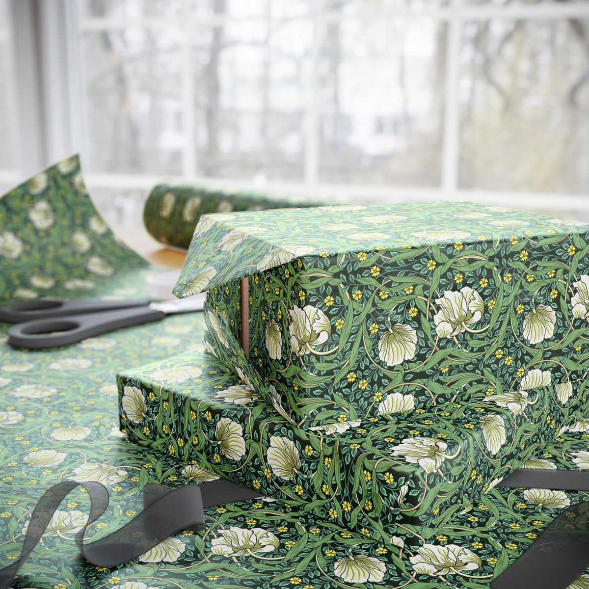 Green floral-patterned gift wrap with scissors on a white background